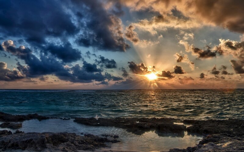 Sunset over Ocean — Blue, Dramatic, Photograph, Clouds, Sun, Rocks