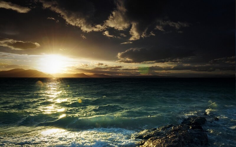 Sunset over Ocean — Blue, Dramatic, Photograph, Mountains, Clouds, Rocks
