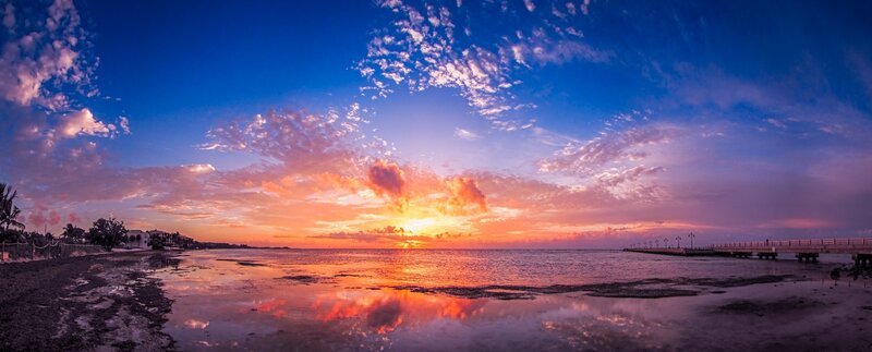 Sunset over Ocean — Blue, Serene, Photograph, Beach, Pier