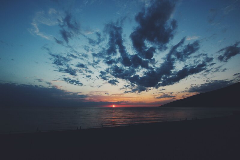 Sunset over Ocean — Blue, Serene, Photograph, Clouds, Beach, Silhouettes