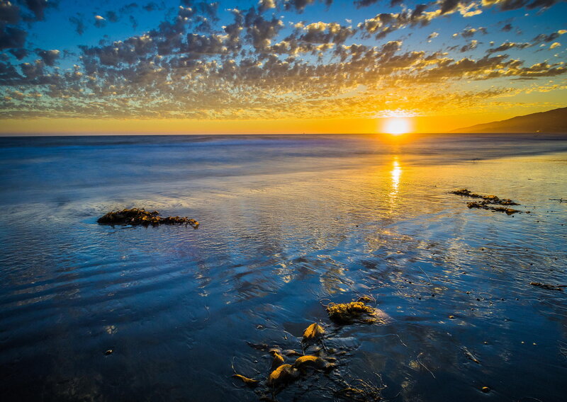 Sunset over Ocean — Blue, Serene, Photograph, Clouds, Sun, Rocks