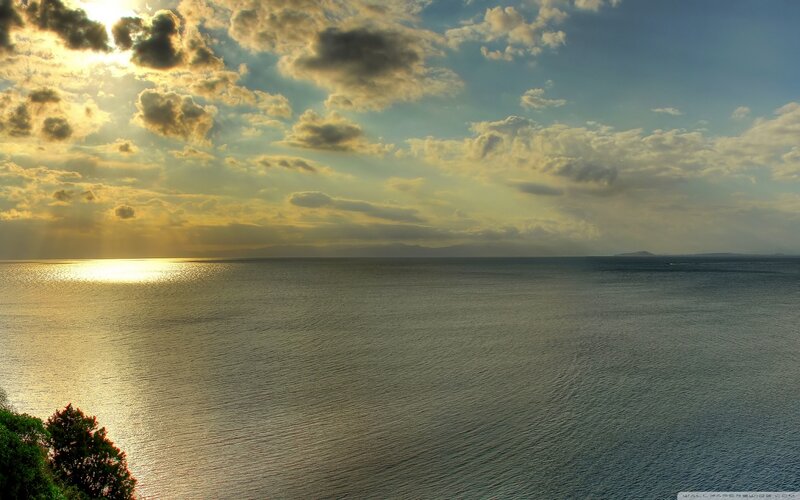 Sunset over Ocean — Blue, Serene, Photograph, Clouds, Sun, Trees