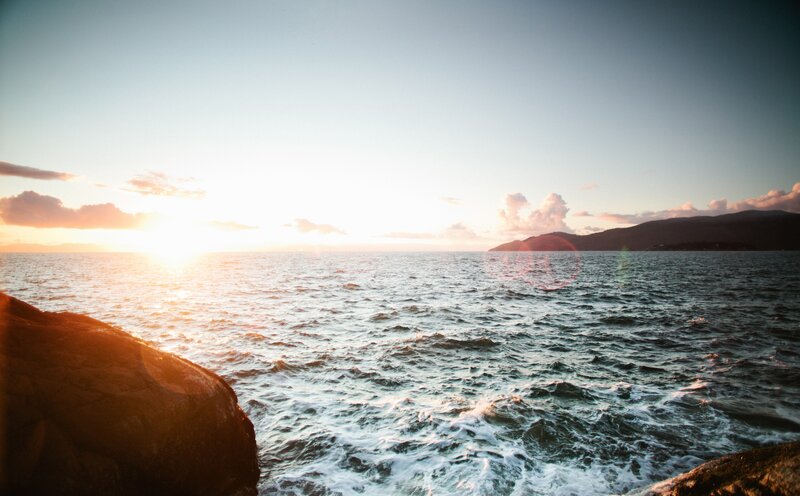 Sunset over Ocean — Blue, Serene, Photograph, Rocks