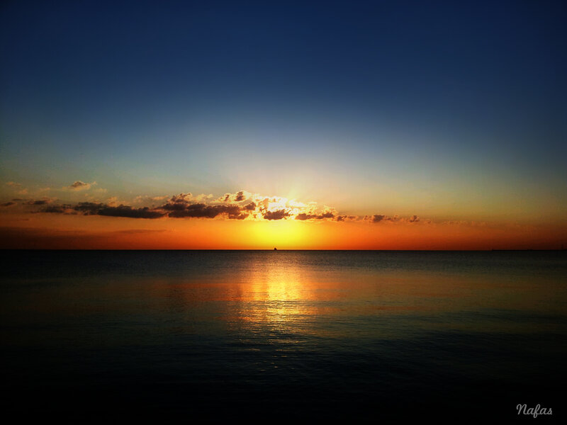 Sunset over Ocean — Blue, Serene, Photograph, Sun, Clouds, Boat