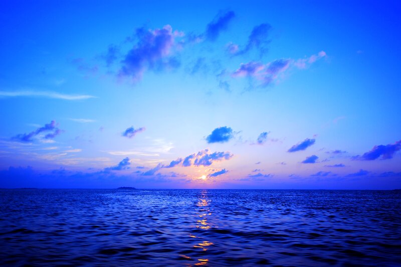 Sunset over Ocean — Blue, Serene, Photograph, Sun, Clouds, Island