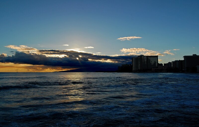 sunset over ocean cityscape
