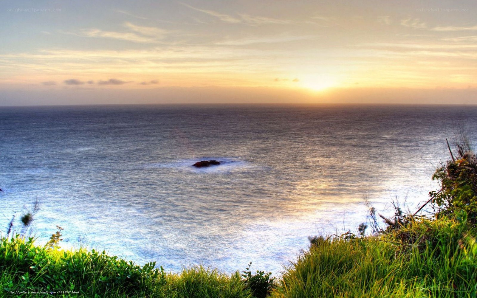 Sunset over ocean cliff