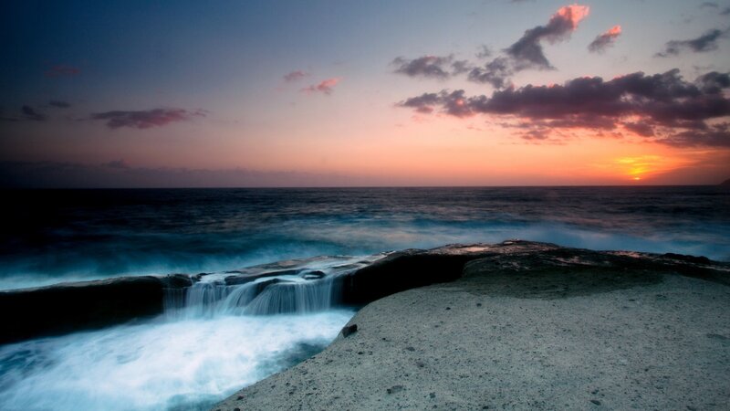 Sunset over ocean cliffs