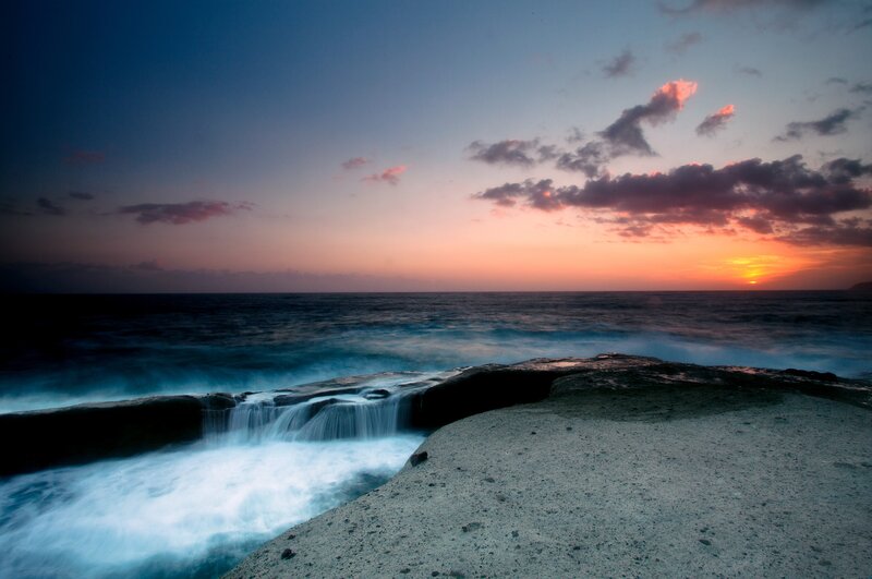Sunset over ocean cliffs