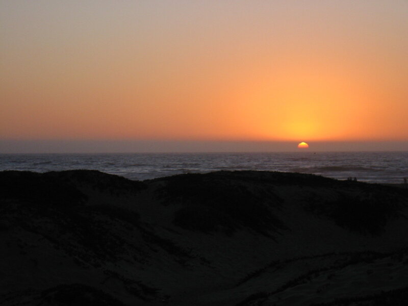 sunset over ocean dunes