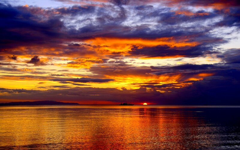 Sunset over Ocean — Orange, Dramatic, Photograph, Boat, Clouds, Sun