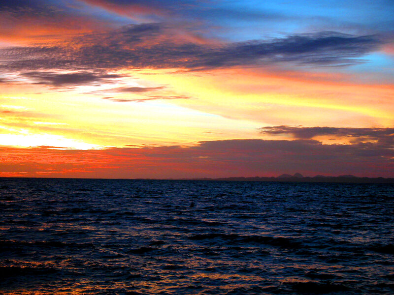 Sunset over Ocean — Orange, Dramatic, Photograph, Clouds, Horizon, Mountains