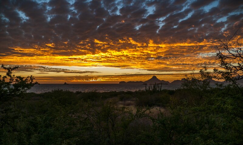 Sunset over Ocean — Orange, Dramatic, Photograph, Clouds, Mountain, Cactus