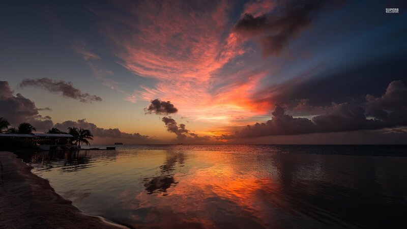Sunset over Ocean — Orange, Dramatic, Photograph, Clouds, Palm Trees, Building