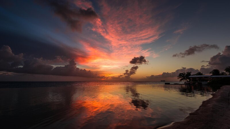 Sunset over Ocean — Orange, Dramatic, Photograph, Clouds, Palm Trees, Pool