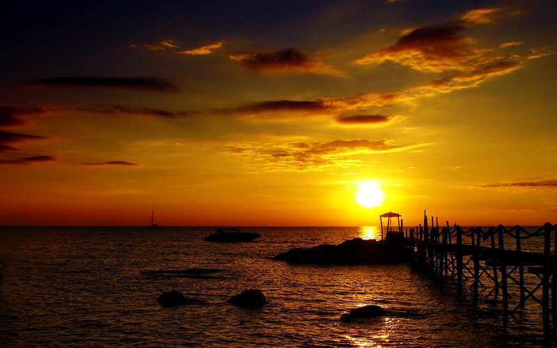 Sunset over Ocean — Orange, Serene, Photograph, Boat, Pier, Clouds