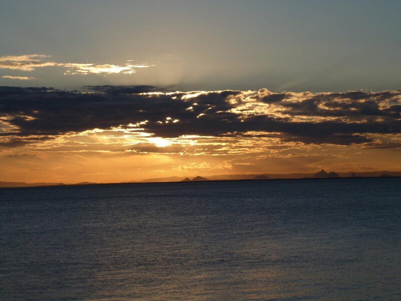 Sunset over Ocean — Orange, Serene, Photograph, Clouds, Mountains