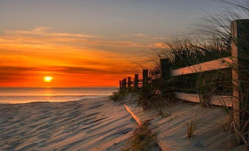Sunset over Ocean — Orange, Serene, Photograph, Sand Dune, Fence, Grass