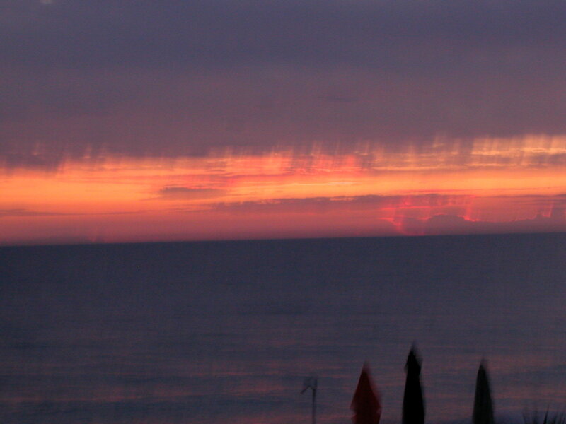 Sunset over Ocean — Orange, Serene, Photograph, Umbrellas