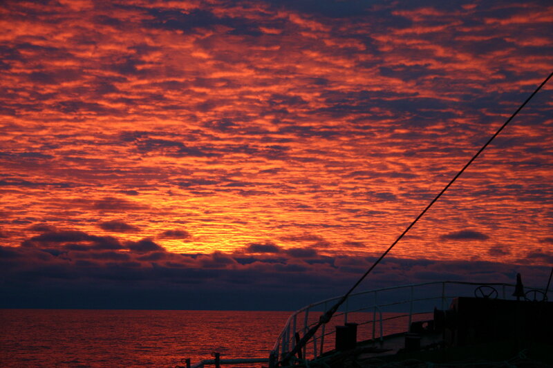 Sunset over Ocean — Red, Dramatic, Photograph, Boat
