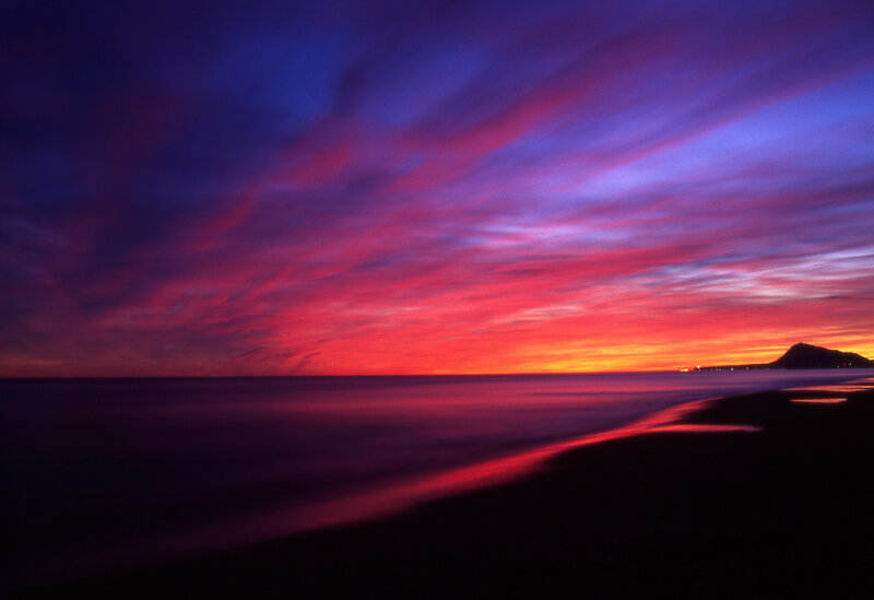 Sunset over Ocean — Red, Dramatic, Photograph, Clouds, Mountain, Beach