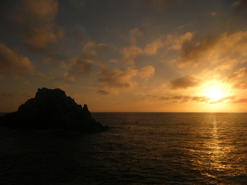 Sunset over ocean rock