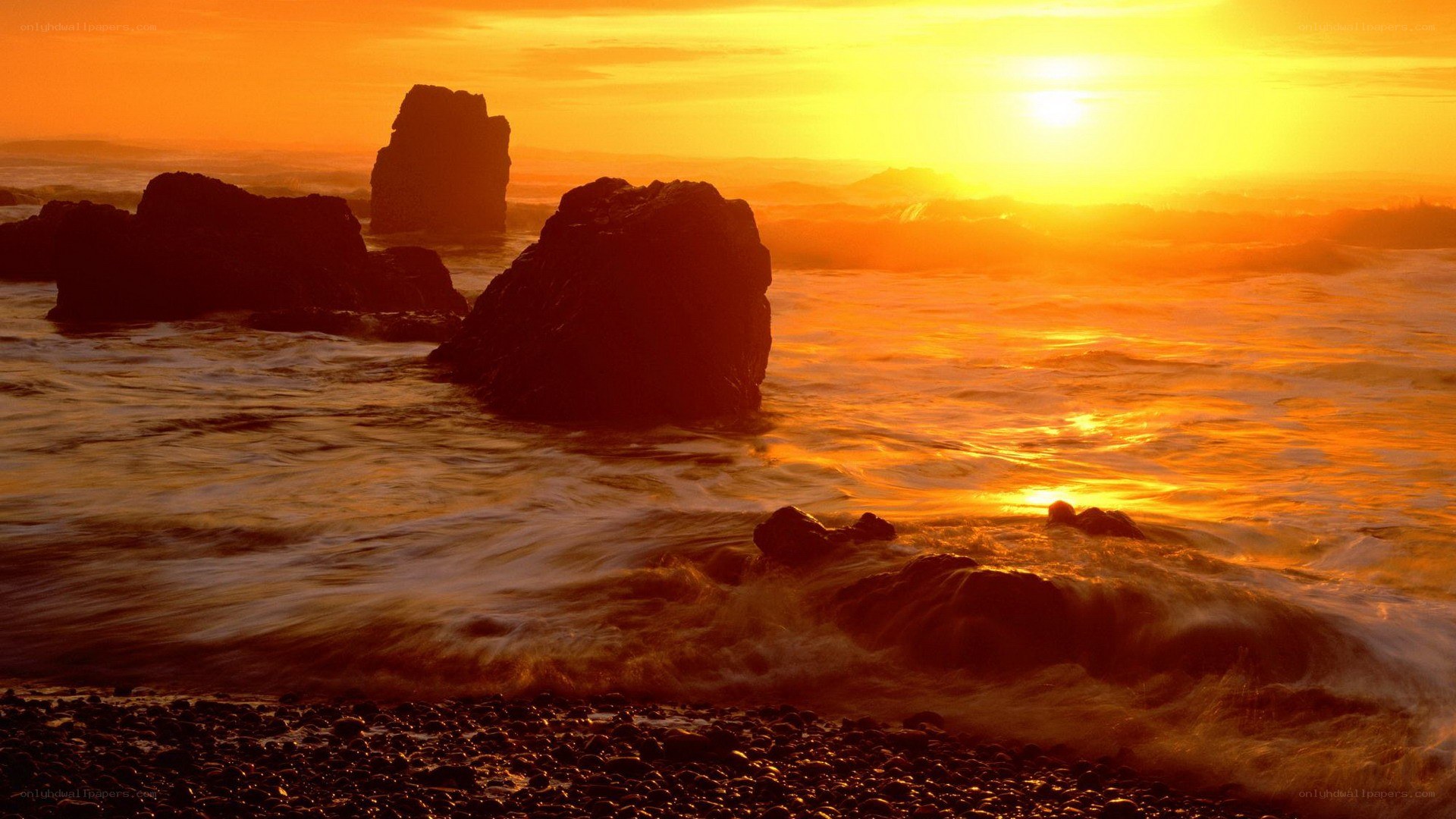 Sunset over ocean rocks