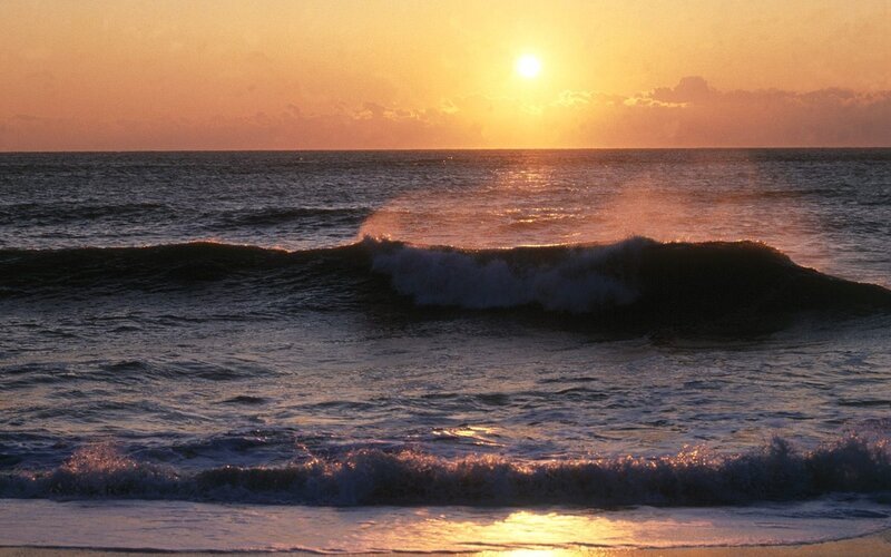 Sunset over ocean waves