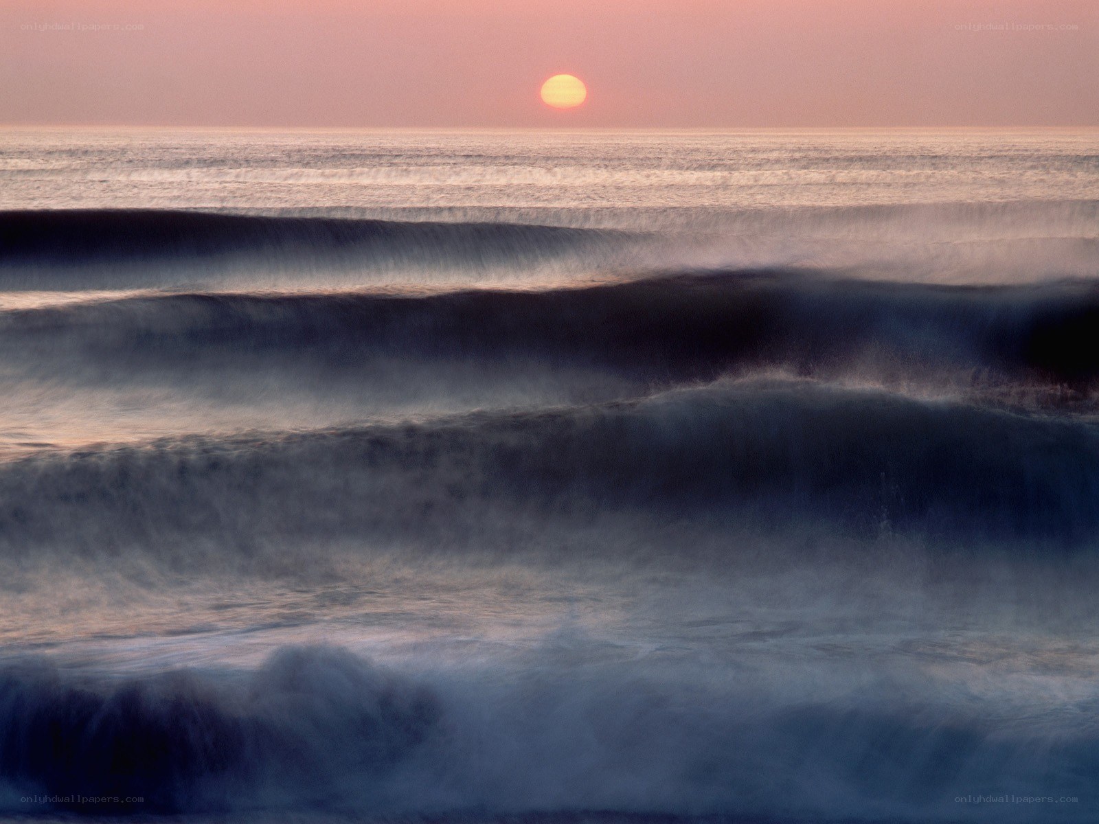 Sunset over ocean waves