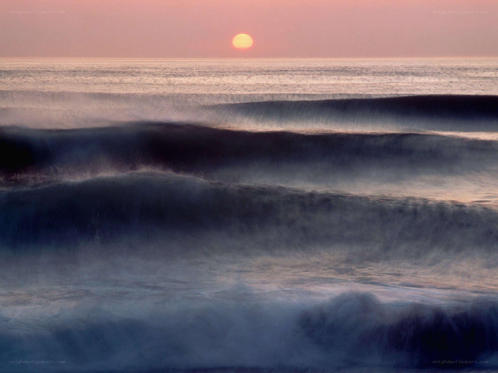 Sunset over ocean waves