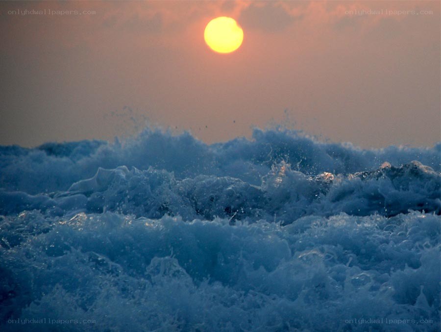 Sunset over ocean waves