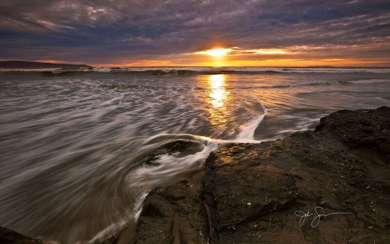 Sunset over Ocean Waves — Orange, Dramatic, Photograph, Rocks, Clouds, Sun