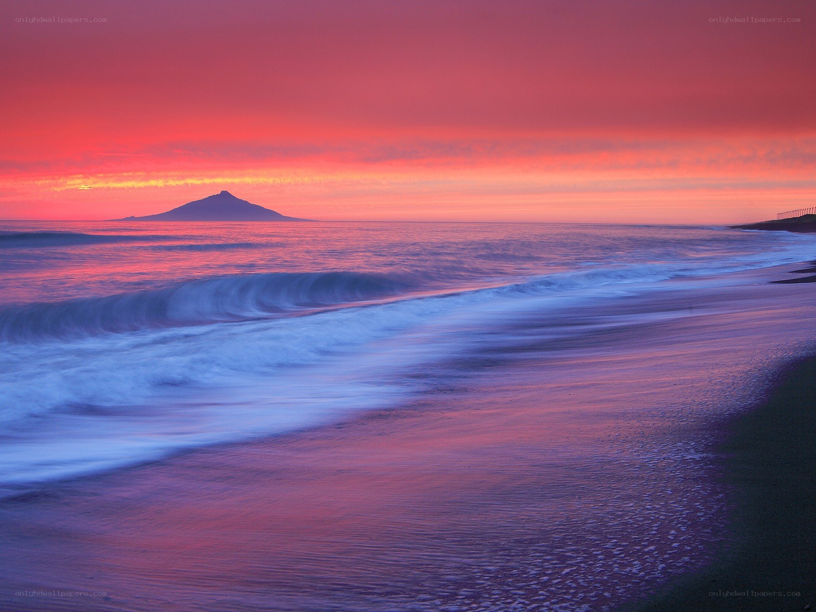 Sunset over ocean with island
