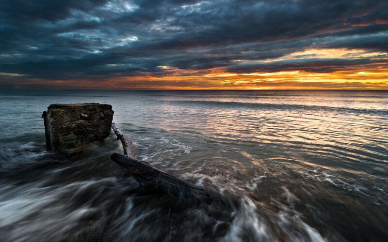 Sunset over ocean wreckage