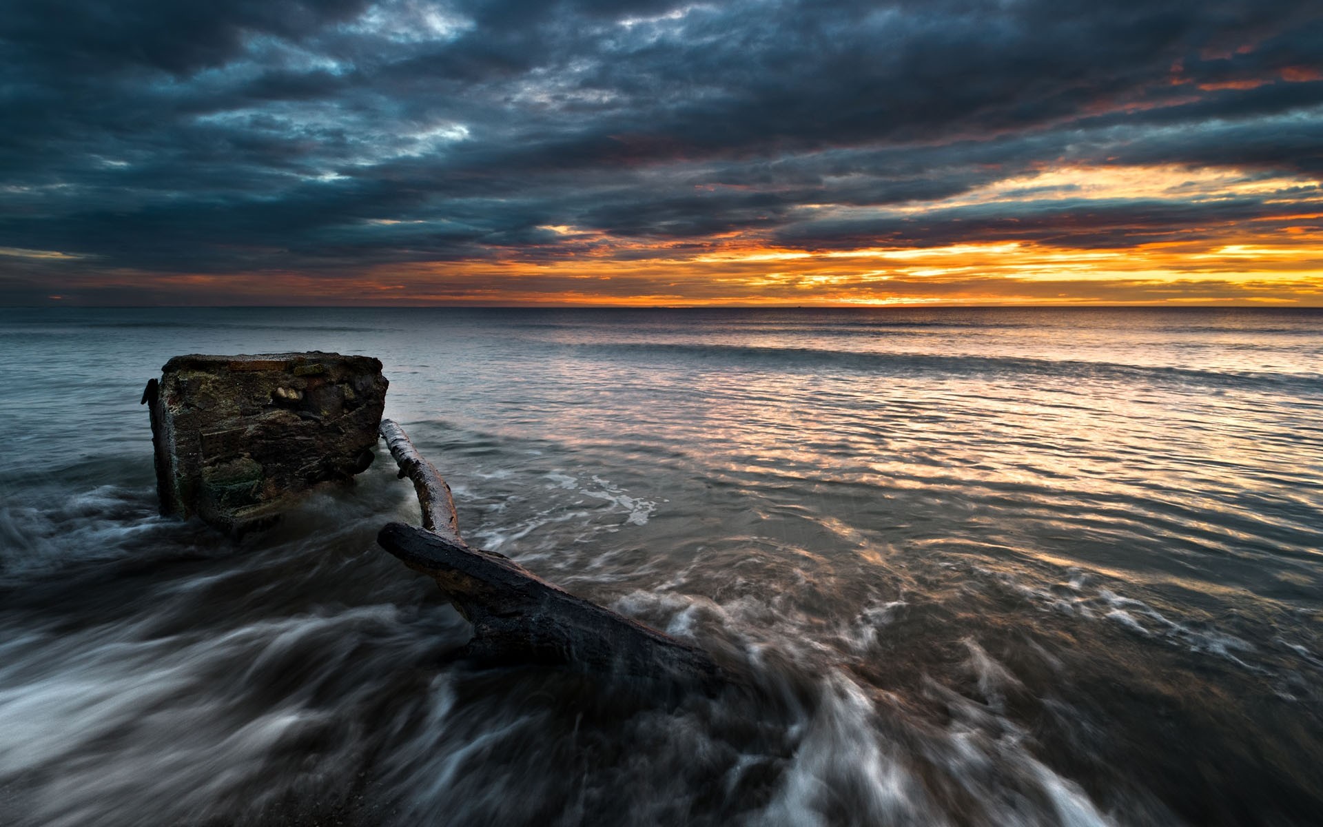 Sunset over ocean wreckage