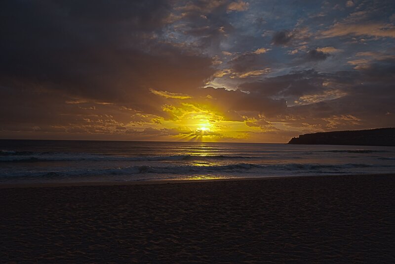 Sunset over Ocean — Yellow, Dramatic, Photograph, Clouds, Beach, Cliff