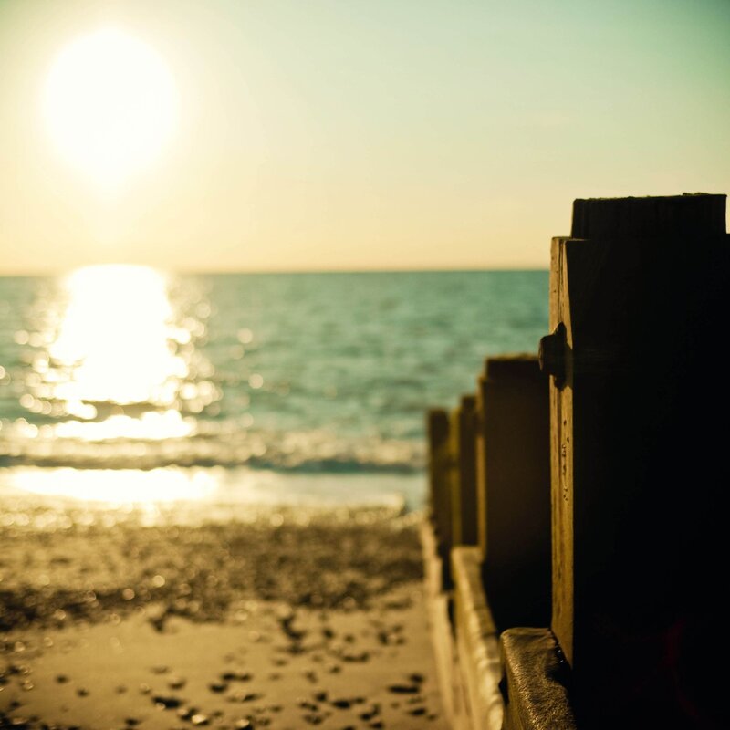 Sunset over Ocean — Yellow, Serene, Photograph, Beach, Wooden Structure