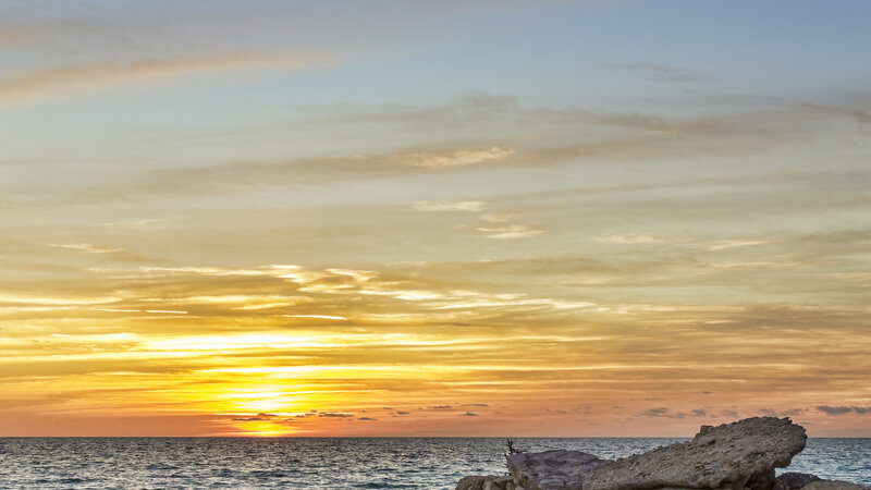 Sunset over Ocean — Yellow, Serene, Photograph, Sky, Rocks