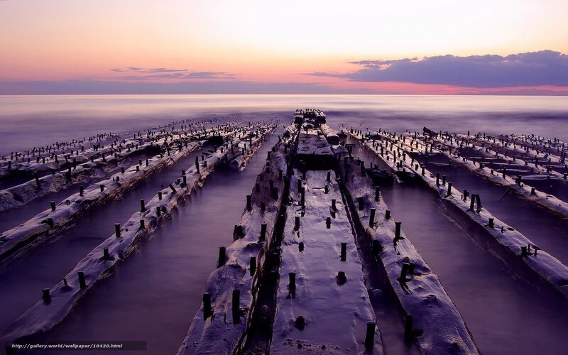 Sunset over old pier ruins