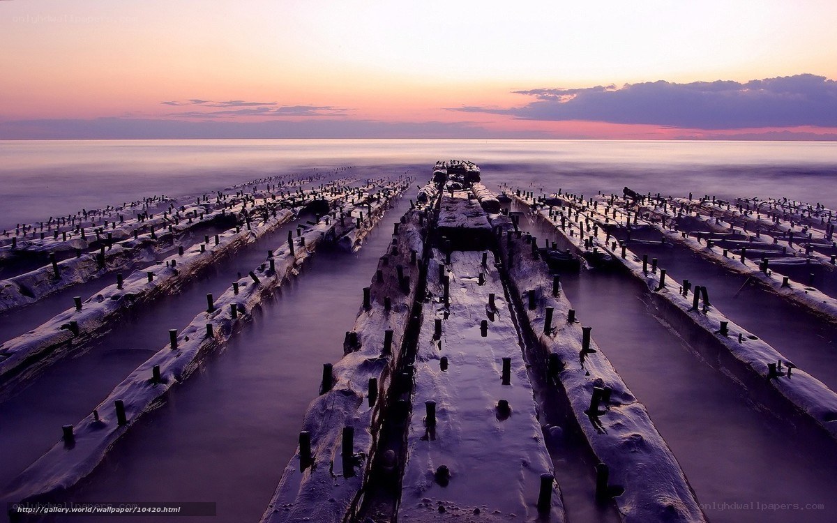 Sunset over old pier ruins