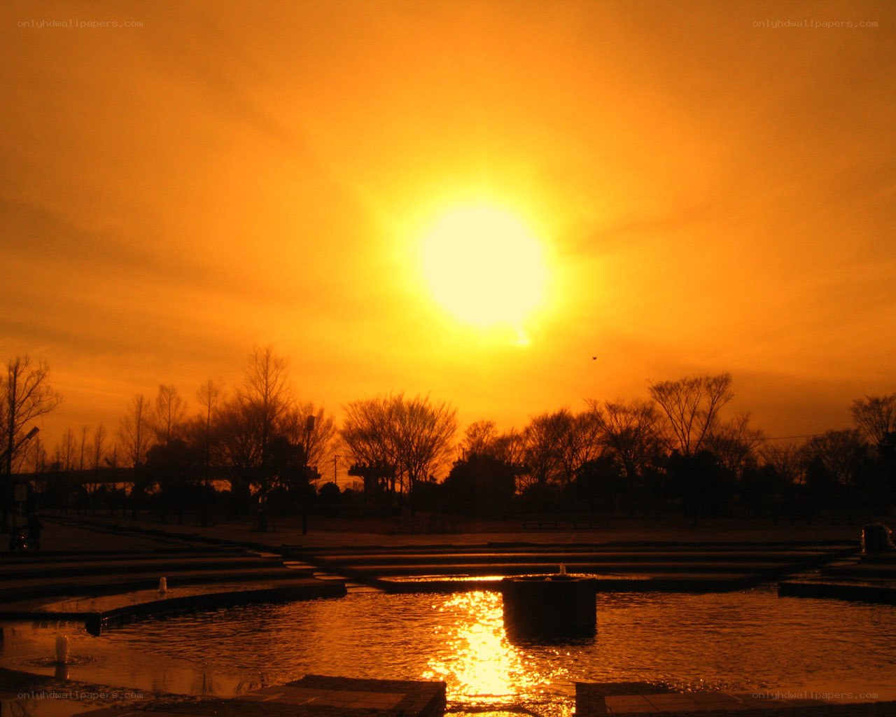 sunset over park fountain