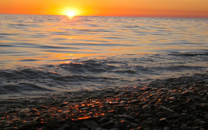 Sunset over Pebble Beach — Orange, Serene, Photograph, Sun, Ocean, Pebbles