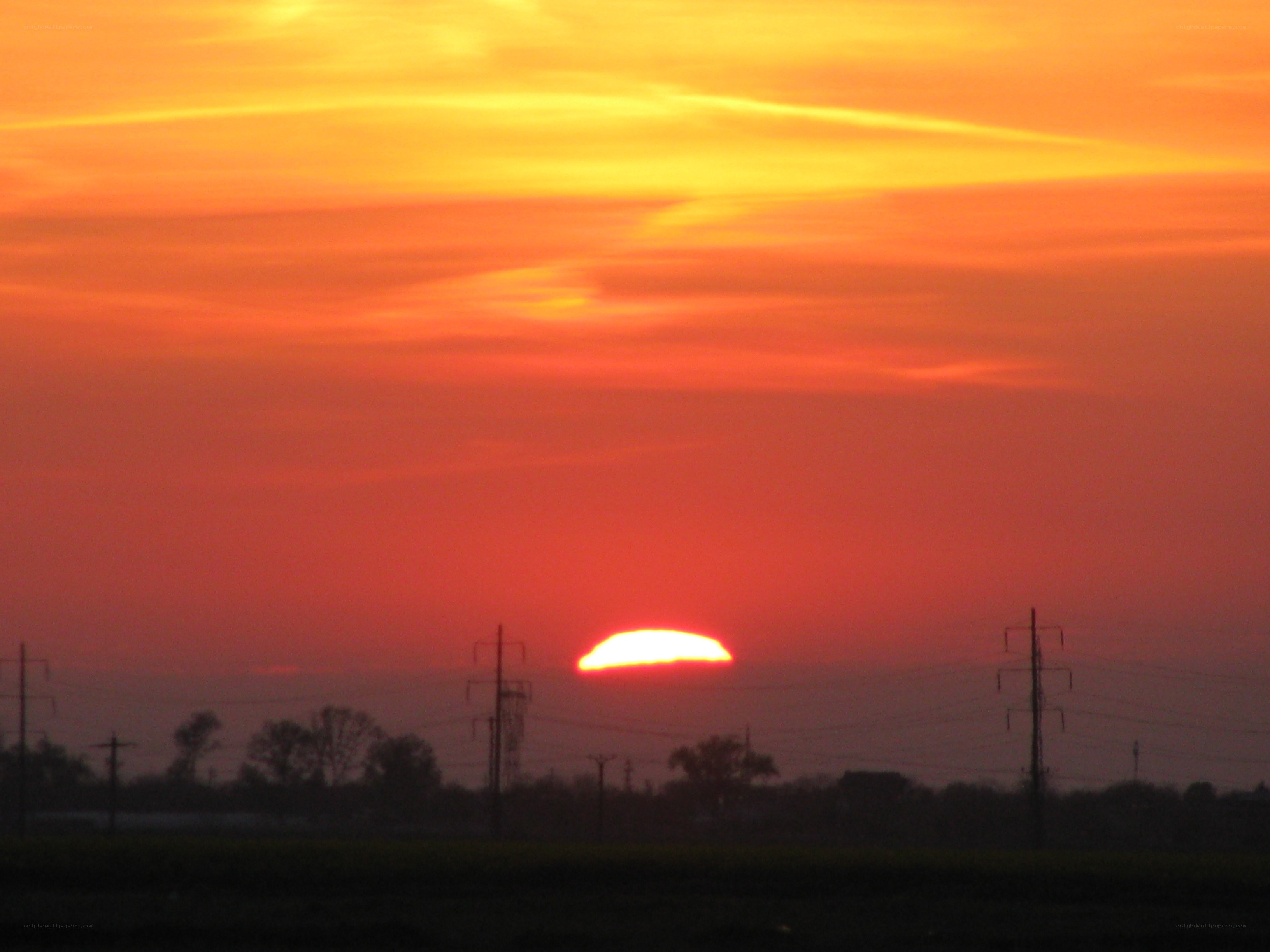 Sunset over power lines