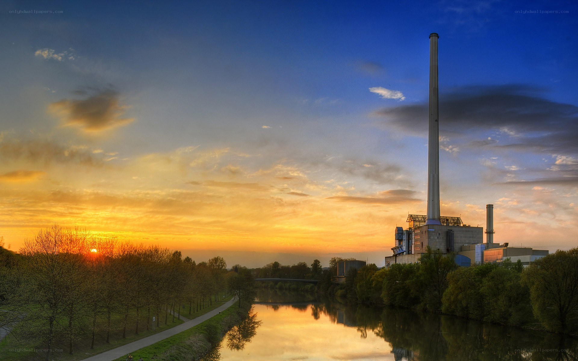 Sunset over power plant and river