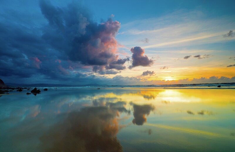 Sunset over reflective beach