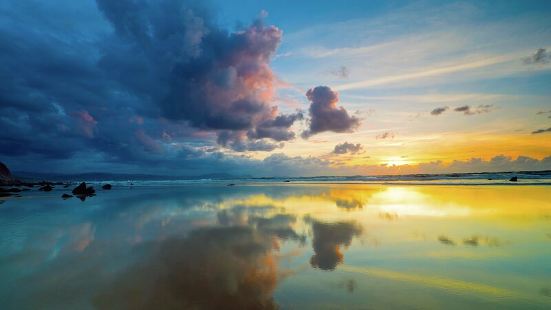 Sunset over reflective beach