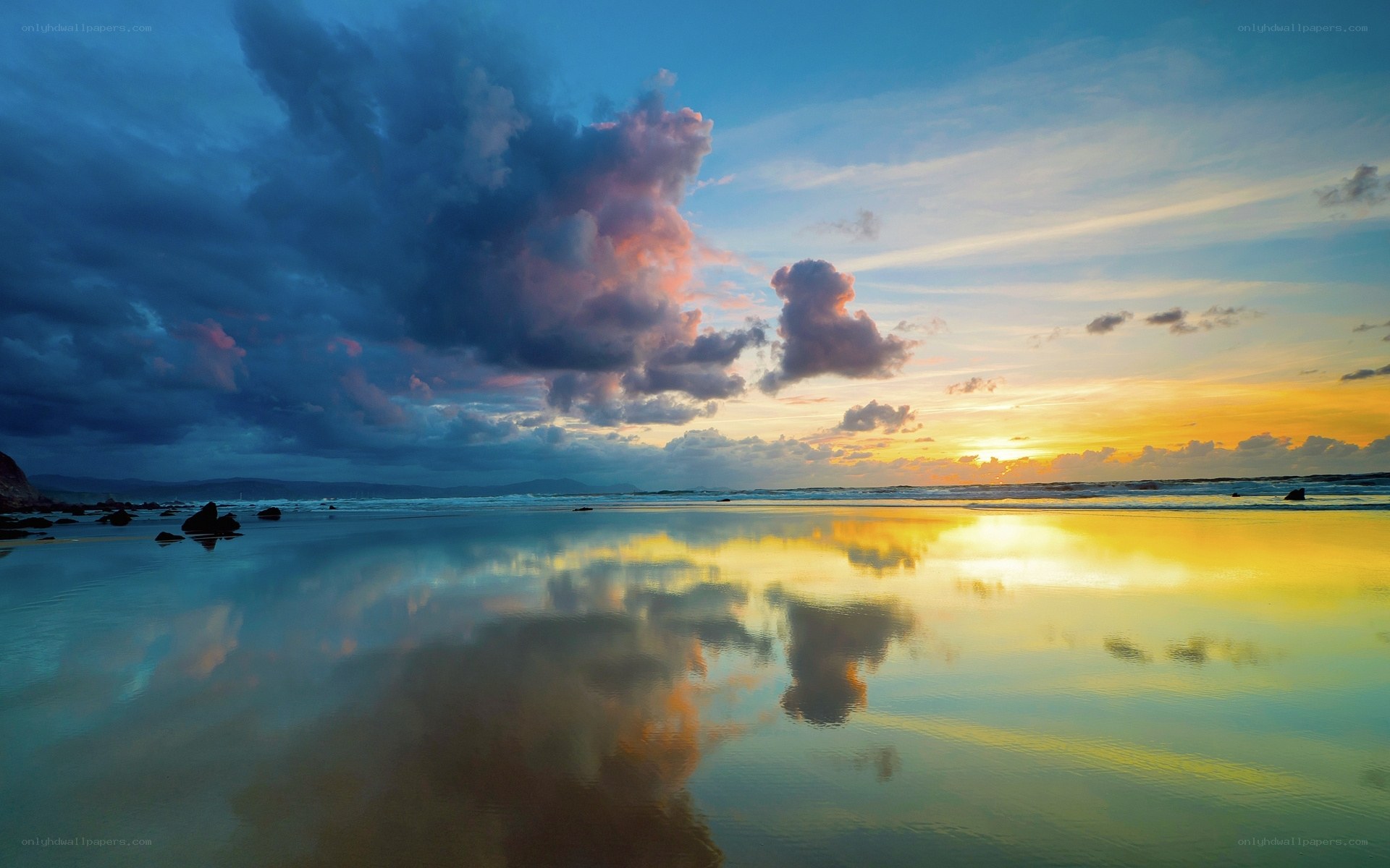 Sunset over reflective beach