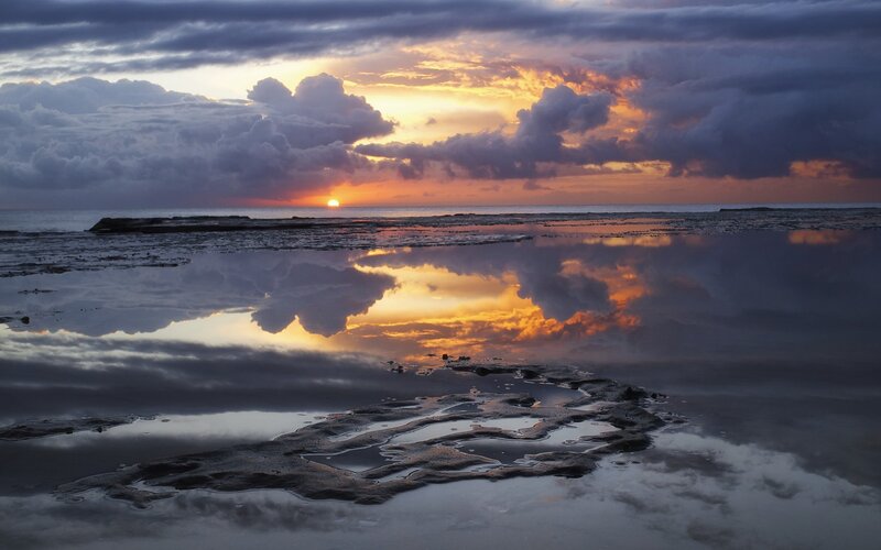 Sunset over reflective tide pools