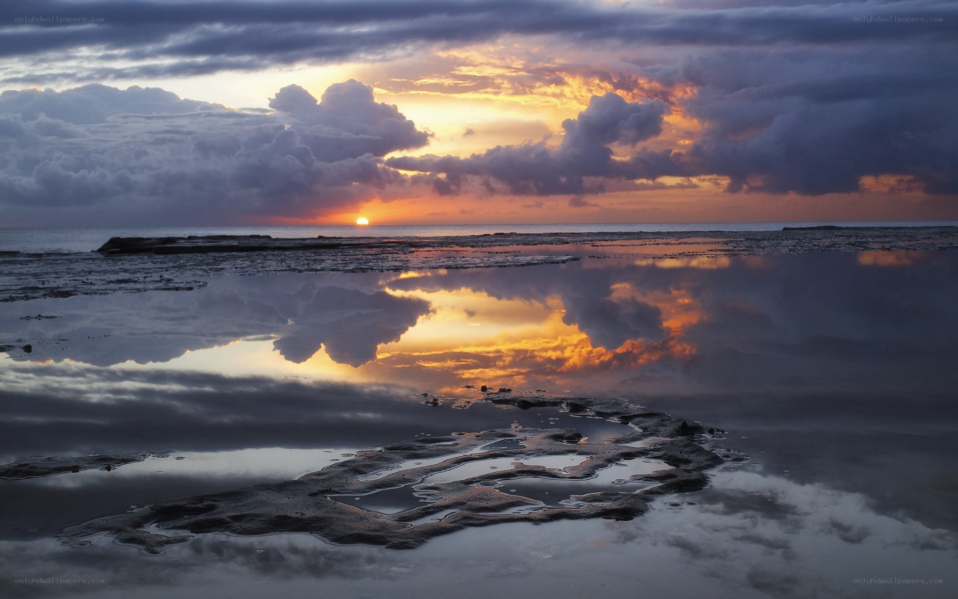 Sunset over reflective tide pools