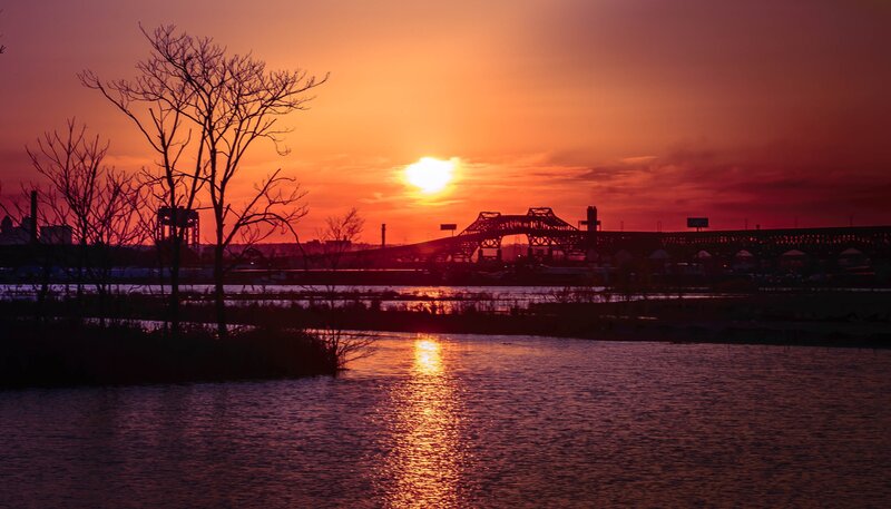 Sunset over river and bridge